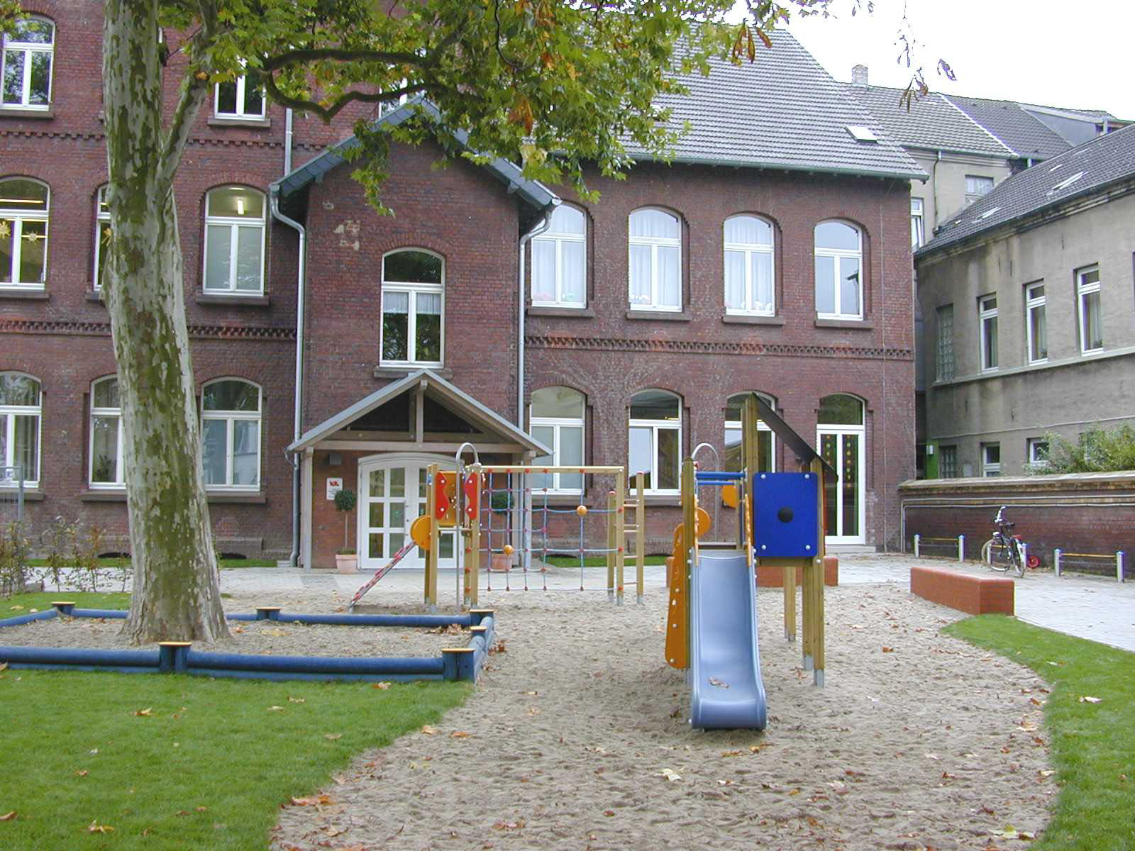 Außenspielbereich und Eingang der städtischen Tageseinrichtung für Kinder Peter-Lauten-Straße.